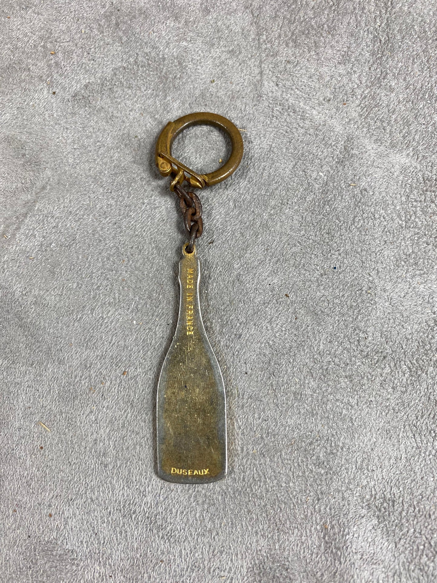 Porte clés Laurent-Perrier en forme de bouteille de champagne vintage Made in France Années 1980