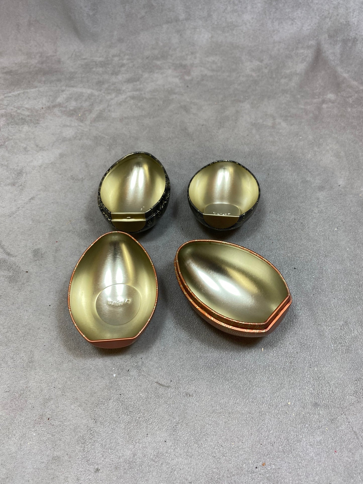 Set of 2 empty red aluminum boxes in the shape of a vintage egg Maxim's de Paris 1990s