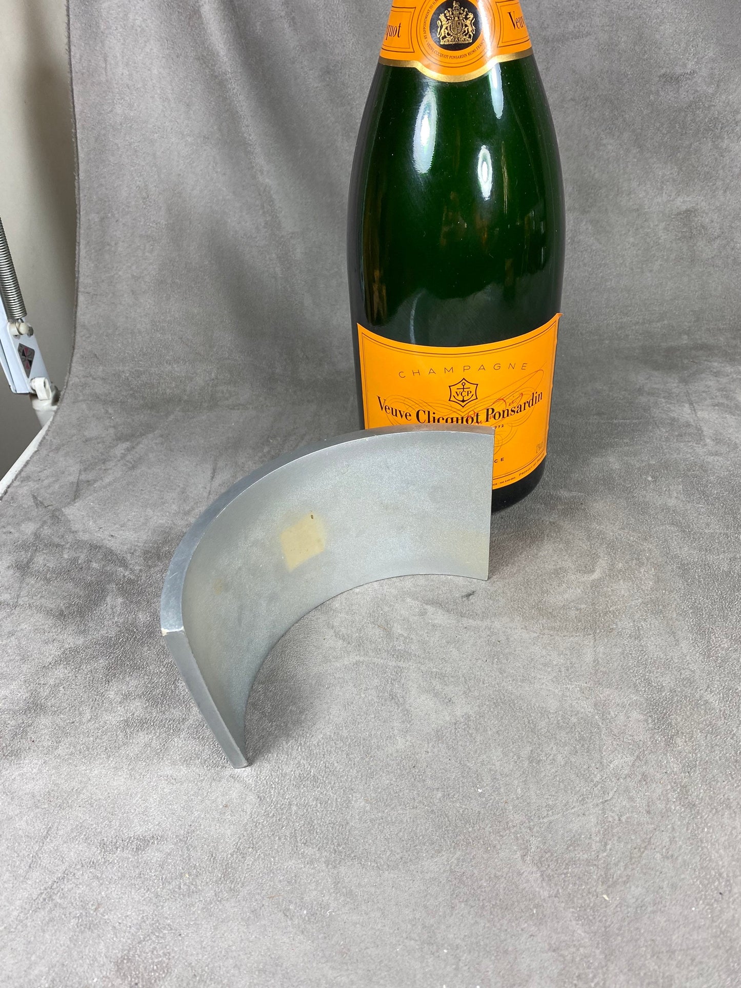 Silver and orange plastic Jeroboam Veuve Clicquot champagne bottle cover