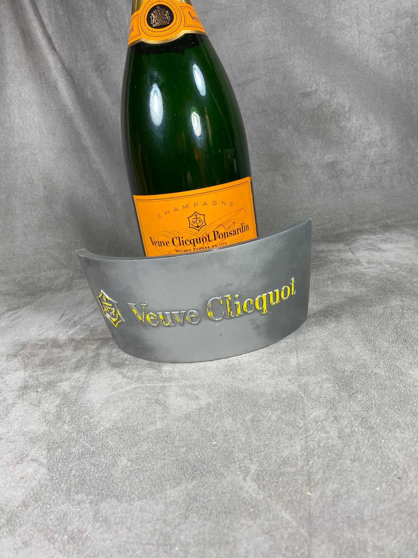 Silver and orange plastic Jeroboam Veuve Clicquot champagne bottle cover