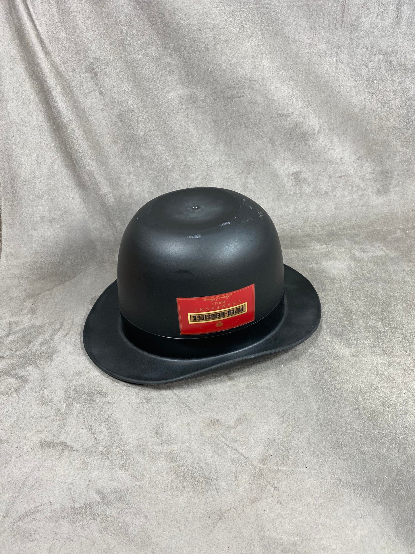 RARE Red and black plastic Piper-Heidsieck Champagne bucket in the shape of a hat from The Avengers collection Bowler hat and leather boots