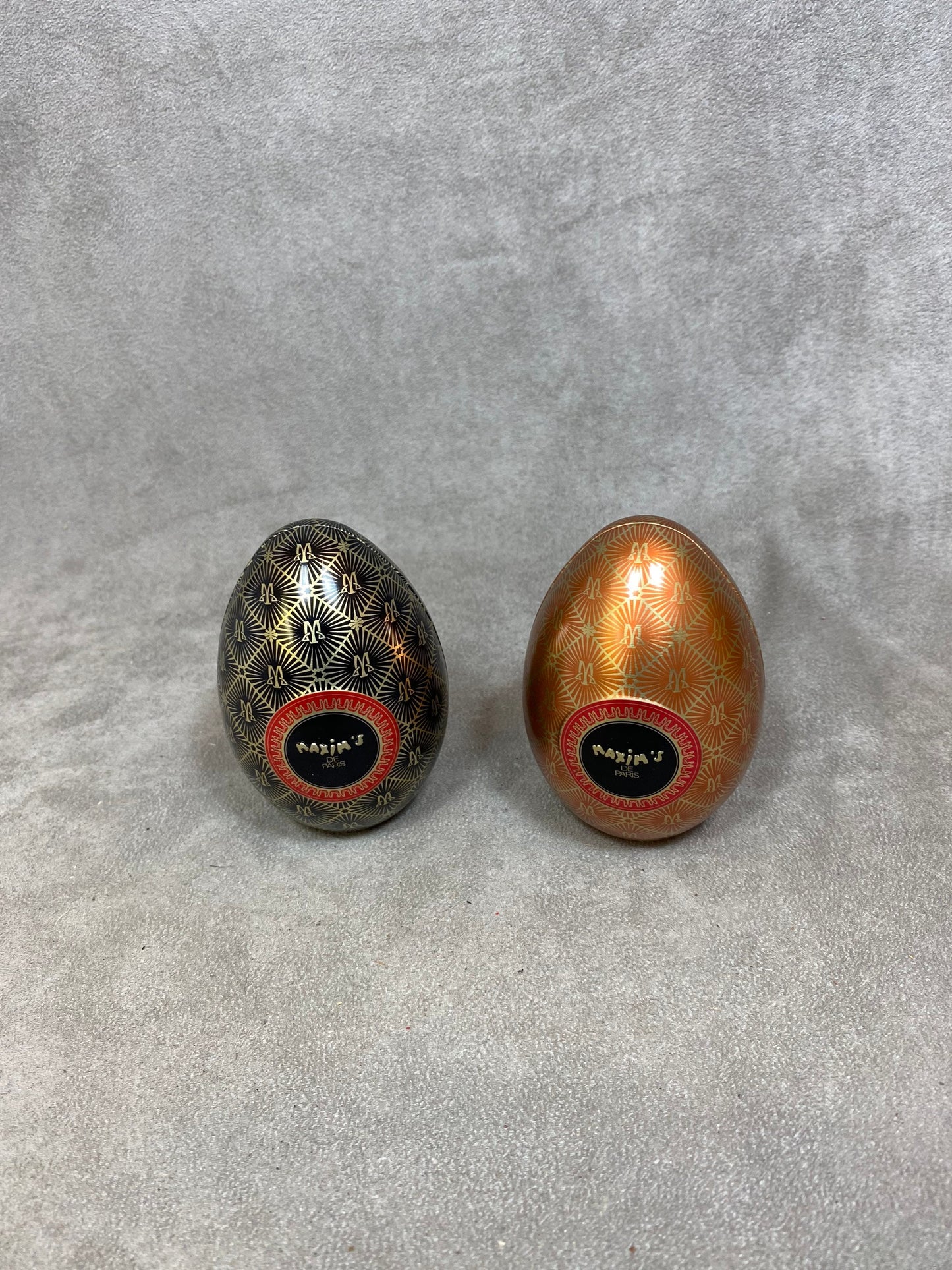 Set of 2 empty red aluminum boxes in the shape of a vintage egg Maxim's de Paris 1990s